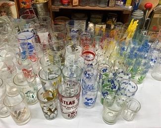 Loads of vintage drinking glasses with a fun variety of patterns and some with advertising. 
