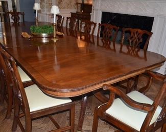 $3,000 Dining Table Mahogany Rosewood  135"W (includes 2 leafs 19 1/2" each) x 5ft D with pads. 12 Chairs covered with leather seats. $5,000