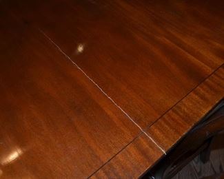Dining Table Mahogany Rosewood (Has a slight crack) 135"W (includes 2 leafs 19 1/2" each) x 5ft D with pads. 12 Chairs covered with leather seats. $5,000