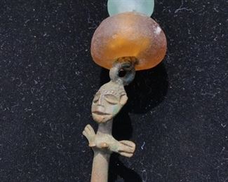 Very primitive carved iron figure with 2 glass stones $20