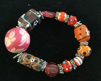 Handmade and hand painted glass beads large pink floral bead is made on a hard clay $15. 