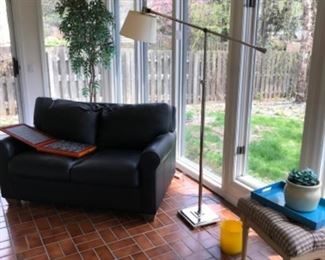 Leather couch and lamp.
