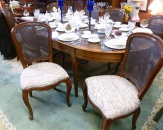 Genuine "Made in France" French Empire-style reproduction dining set of table (with leaves) plus 8 machine-caned back dining chairs.  Original printed cotton seats in good condition.  Originally priced @ $2,400.  We have sales receipts showing original purchase price at over $6,000.  Now offered at $1,000.  Table can be reduced to size for only 4 people.
