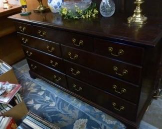 Dresser/chest of drawers with brass pulls, in good condition, originally tagged at $254, now offered at $100 because it is heavy dark furniture.