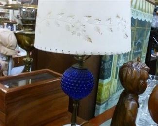 This table lamp has a spherical molded dark blue "button" font over metal post over 2-tier round white marble base.  Piercecut paper shade may be original to it -- shows light nicely through the shade when other lights are turned off -- at $40