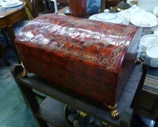 Red leather-clad coffer-style chest on feet @ $60