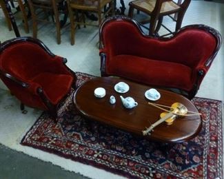 Child-scale armchair and setter matched with a diminutive oval coffee table, miniature tea set, and miniature violin.  Chair @ $32.  Settee @ $54.