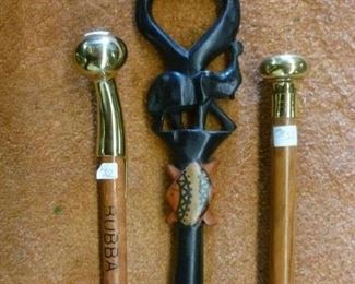 Each of the brass-topped walking sticks @ $32.  The handcarved ebonized wood cane with elephant @ $54