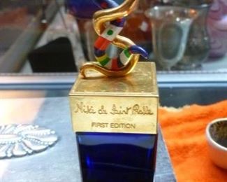 This perfume bottle with colorful entwines snakes on lit, offered at $18