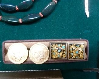 Cufflinks include pair of goldplated coins @ $36/pair and square tops of turquoise and gold flecks at$26/pair