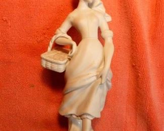 Porcelain bisque female figure holding basket, approx 7"h, @ $24