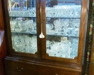 Display cabinet in two pieces:  top glazed cabinet with interior lights, mirrored back, 2 glazed door, over base cabinet of 2 drawers with Chippendale-style brass bail handles, now reduced to $200