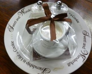 Scented vanilla candle in demitasse cup accompanied by glass salt/pepper shakers on plate @ $18