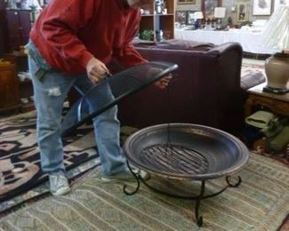 Note one of our clients showing off the "fire pit" that he took out of the box and put together, the fire pit offered @ $40