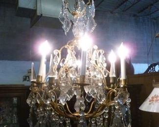 This is a FINE chandelier, about 32"h x 16"d, having six simulated lighted candles alternating with clear pyramidal spikes,  offered at $494