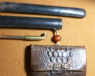 Opium pipe fits into 2-part leather (shagreen?) case from which is suspended a reptile skin case separated by amber-type bead.  Case still contains dried fiber.  Entirety for this very rare ensemble is $394.
