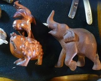 Hardwood carving of boy standing on hands on a toad plus a happy walking baby elephant