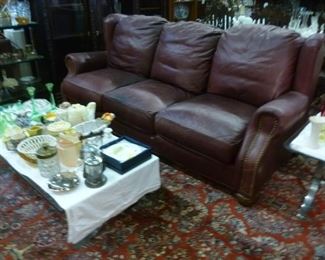 Three-seater dark brown leather sofa now reduced to $100 because we do not want to have to move it again.