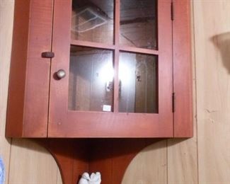 Hanging corner cabinet with red paint, interior shelf fitted to hang spoons.  Note tiny shelf underneath.