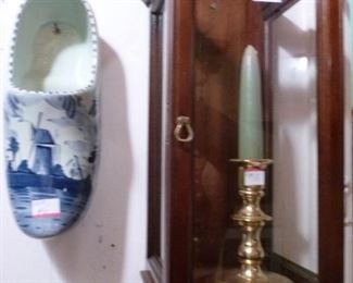 On the left is a handpainted ceramic Dutch shoe.  On the right is a candlebox with front door, open top, in which we have put a brass candlestick.