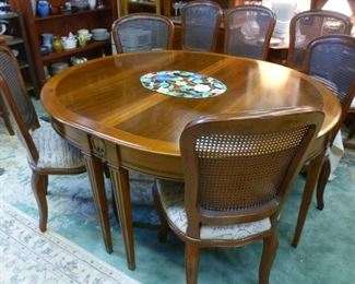 Note the oval French Empire-style (actually made in France) dining table surrounded by 4 caned-back chairs.  The table comes with two leaves so can be opened up to accommodate 8 matching chairs.