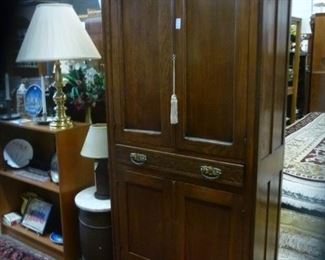 American antique cabinet having medial drawer flanked above and below by pair of doors, and period hardware, nicely refinished.  We have replaced the flimsy shelves with cedar.  Open it to inhale the nice smell.  Offered at $100.