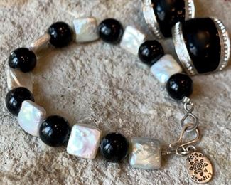 Mother of pearl bracelet by Del Sol Jewerly. $10. Clip on earrings black with faux diamonds. $8. 