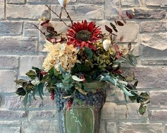 Decorative faux floral with green base. Measures approx 2.5’ H x 2’ W. $30