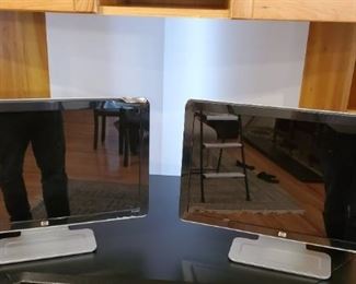 Two HP 23-inch monitors. Both in working condition. One with damaged corner.