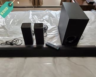 Sony Active SA-RT5 Soundbar with a subwoofer and two wireless surround rear speakers, and a remote control.
