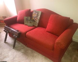 OKAY, back to the story. Red loveseat with throw pillows, three of which look really uncomfortable