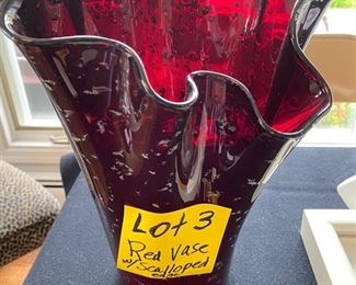 Lot 3.   $15.00 Cranberry Colored Large Glass Vase with Ruffle Fluted top, Asymetrical.  10.5” H x 9.5” D x 9.5” W  Would look terrific with tall cut flowers!