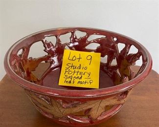 Lot 9. - $18.00 Studio Pottery with red rim, reticulated sides featuring a leaf motif around the middle.  Signed by artist on the bottom.
