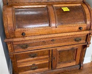 Lot 12. - $225.00.  Really Cool Antique Roll Top Desk with Burl Wood Inserts 44”W x 23” D x 44.5” H - We like the way this roll top opens on a curve.  This piece has a wonderful combination of form and function!  