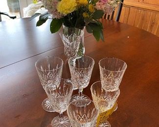 Lot 24:  $150.00   6 Waterford Lismore pattern wine/goblet stems in 2 sizes (Three 7” Stems and Three 6” Stems plus Bonus 1 Waterford Toasting Flute, in the rear.  All in perfect condition