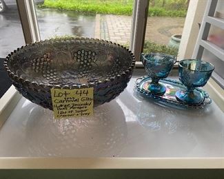 Lot 44.  $40.  Two more pieces of carnival glass - a very large bowl with grape clusters in relief, (could be used as a punch bowl, and a lovely peacock blue-footed creamer and sugar bowl, with a darling tray underneath.  The bowl is the same color and style as the Fenton Covered Candy dish presented earlier, but I do not see a mark on this bowl.  Great deal.
