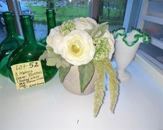 
Lot 52. $18.    Green glass bottles, Milk glass vase and pot with artificial floral arrangement 
