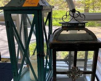 Lot 60. $32.   Two outdoor lanterns.  The green one is made of wood with missing glass on two sides, vintage-inspired and 28" tall.  The other has a weathered look and is 20" tall. Great looks for your deck or patio
