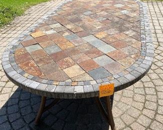 Lot 63.   $50. Oval Tile Top Table from Costco, 79"x42" - the base is metal and resin.  Thre are a few imperfections on the tile top, and a few tiles need to be super-glued down, but attractive table.  Large size will accomodate a good size family!