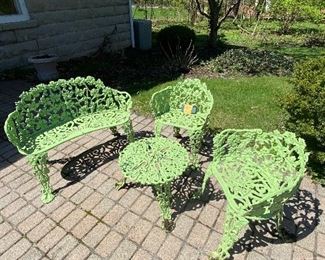 Lot 64.    $325. Here is an Antique Victorian four-piece  cast iron patio set, painted a lime green for dazzling.  (Could use another spray coat of paint and a little love) but structurally sound.   Set includes 1 bench or settee 38" wide, 2 chairs 22" wide and 1 round table 20" in diameter.  All seats are 13.5" off the ground.  Note:  for a similar 3 piece set, this is priced at $1400 online.    