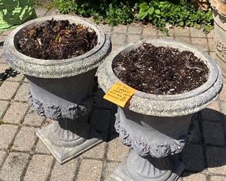 Lot 65 $40.   2 pedestal composite planters.  Composite is better because concrete is too darn heavy after you add soil.  Planters are 13 in wide, whole unit is 23" tall.  Leaf design at base of pots.   Note:  If you purchase these, you do need to take the soil in them too - and you'd be crazy not to.  So bring a tarp or something so the soil doesn't get all over your vehicle.  Soil looks good and you can plant right in them. 