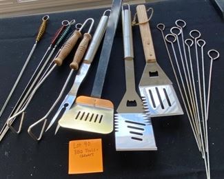 Lot 90.   $12. Lot of BBQ  utensils.  Includes 3 spatulas, 1 large fork, one set of tongs, and two sets of kabobs.  All that's missing is the Steak!