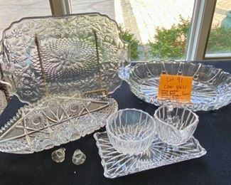 Lot 91.  $18.  An assortment of 6 glass items as shown above and in next photos.  Includes one oblong glass tray, two other glass bowls, one creamer and sugar and tray beneath. 