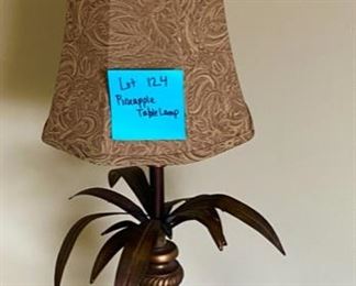 Lot 124.  $ 50  Pineapple Table Lamp.  Has a $120 pricetag on the bottom = bronze in color