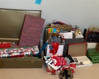 Lot 128.    $25. Whole lot of Christmas wrappings. includes bins.  Includes vintage metal holding box and tons of bags, wrapping, ribbons, more...