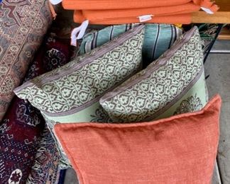 Lot 137. $45.  Lot of Sunbrella branded seat cushions in a pretty orangey/coral color and more outdoor pillows. Seats measure 18"x18". 