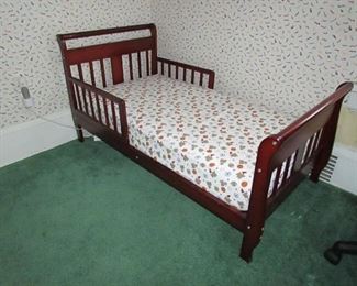 Toddler bed with cherry finish. 29"w X 28"h X 56"long. (Mattress and fitted sheet is included). PRICE: $75.00