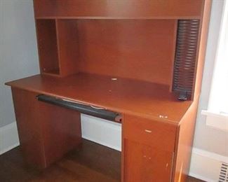 Compressed wood computer desk with CD storage. Wear to surface. 54"w X 58"h X 24"d. PRICE: $20.00