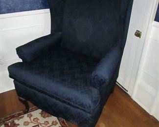 American Furniture Co. of Mississippi Queen Anne-style wing chair with navy blue "flame stitch pattern" upholstery. 7" diameter stain to fabric as seen in picture. 29.5"w X 42"h X 28"d. PRICE: $40.00