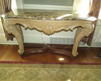 "Kathy Ireland Home" ornate carved French-style console table with 2-tone painted finish and faux stone top. 52"w X 28.5"h X 18"d. PRICE: $150.00